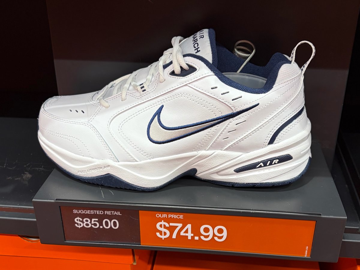 Nike Air Monarch IV on a Nike outlet shelf with its price tag
